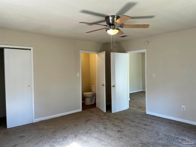 unfurnished bedroom featuring connected bathroom, ceiling fan, and carpet floors