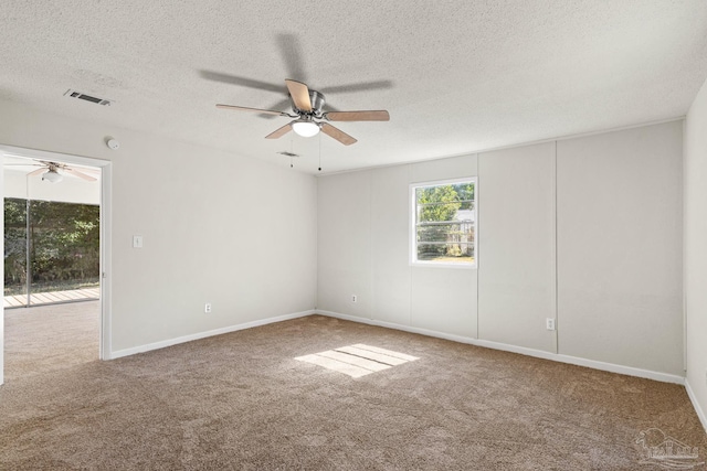 empty room featuring carpet floors, a textured ceiling, and ceiling fan