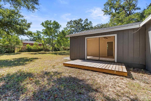 view of yard featuring a wooden deck and ceiling fan