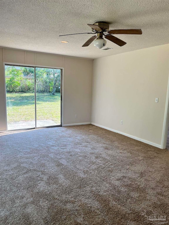 spare room with a textured ceiling, carpet flooring, and ceiling fan