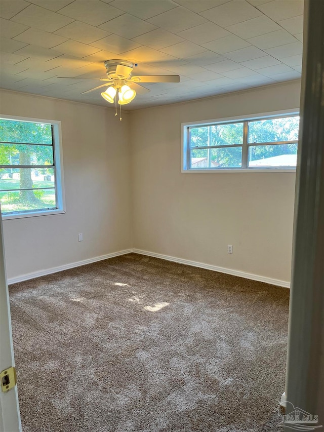 carpeted empty room featuring ceiling fan