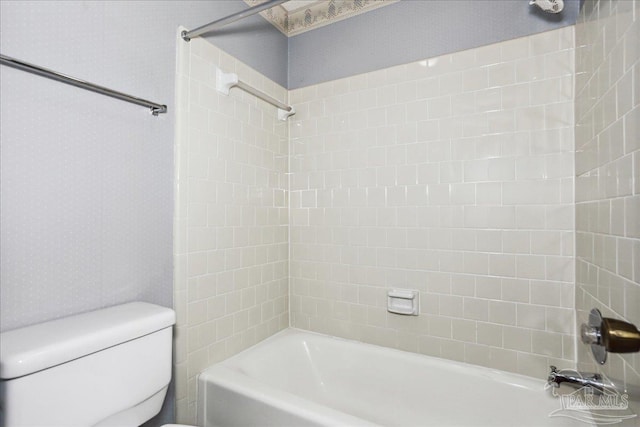 bathroom with shower / bathtub combination and toilet