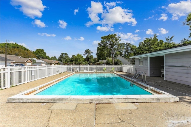 view of swimming pool featuring fence, a fenced in pool, and a patio