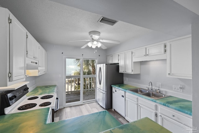 kitchen featuring white appliances, white cabinets, ventilation hood, sink, and ceiling fan