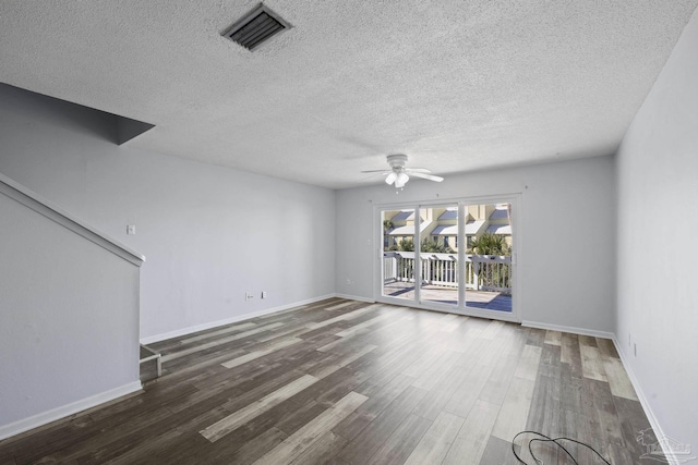 unfurnished living room with ceiling fan, dark hardwood / wood-style flooring, and a textured ceiling