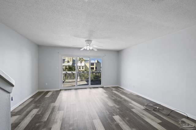 spare room featuring ceiling fan, dark hardwood / wood-style floors, and a textured ceiling