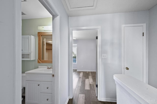 bathroom with vanity, wood-type flooring, and a textured ceiling