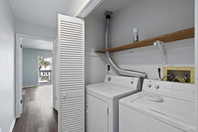 washroom featuring dark hardwood / wood-style flooring and washer and clothes dryer