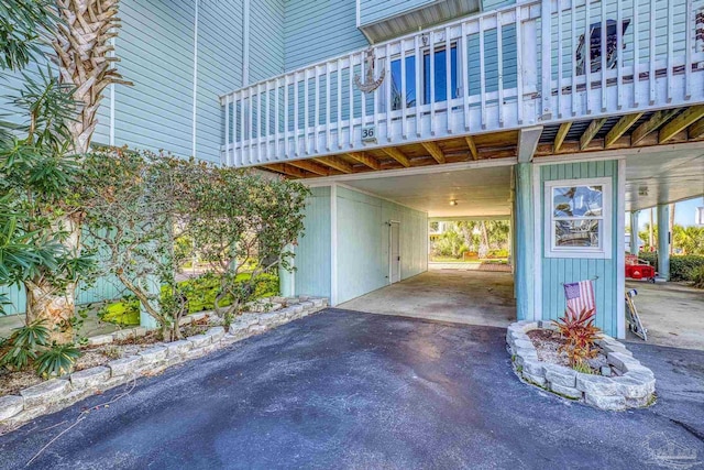 exterior space featuring a balcony and a carport