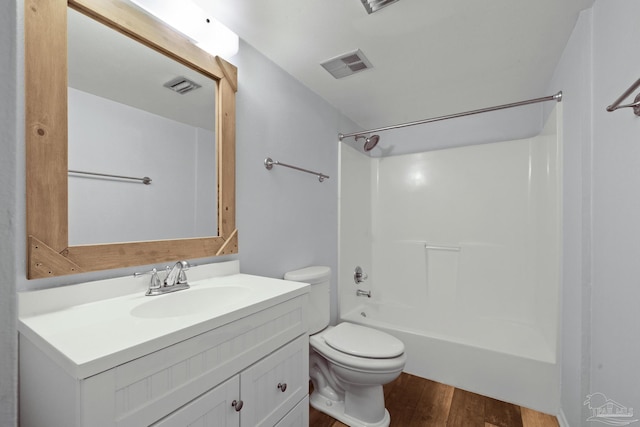 full bathroom with hardwood / wood-style floors, vanity,  shower combination, and toilet