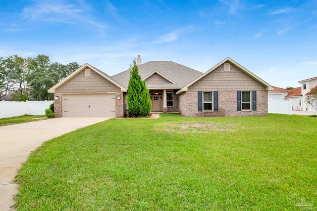 view of front of house with a front yard and a garage