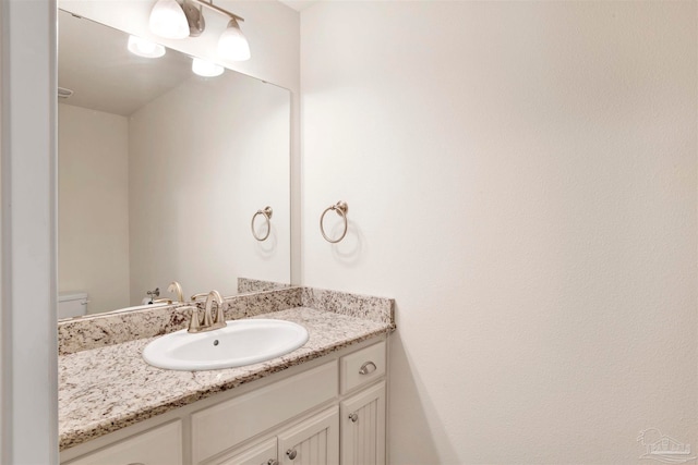 bathroom with vanity and toilet