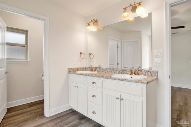 bathroom with hardwood / wood-style floors and vanity