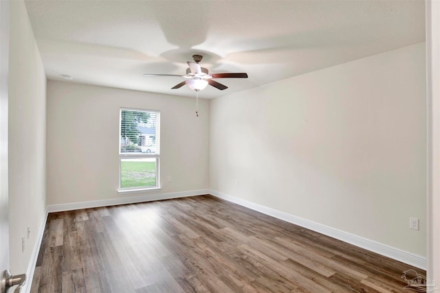 spare room featuring wood-type flooring and ceiling fan