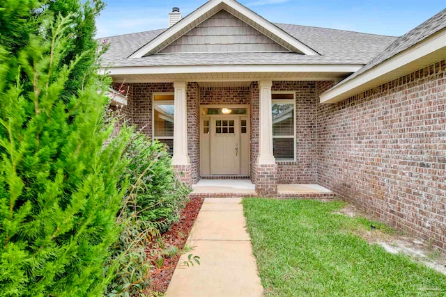 view of exterior entry featuring covered porch