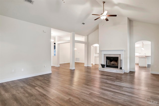 unfurnished living room featuring ceiling fan, dark hardwood / wood-style flooring, high vaulted ceiling, and sink