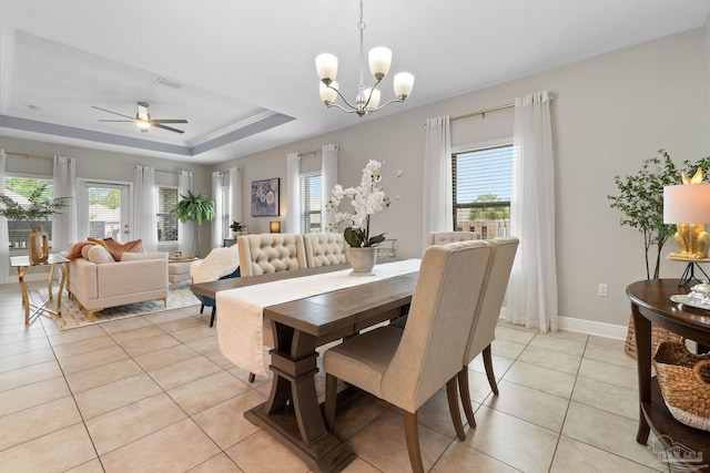 1777 Waterford Sound Blvd, Gulf Breeze, FL 32563 - dining space featuring plenty of natural light, light tile patterned floors, a tray ceiling, and a chandelier