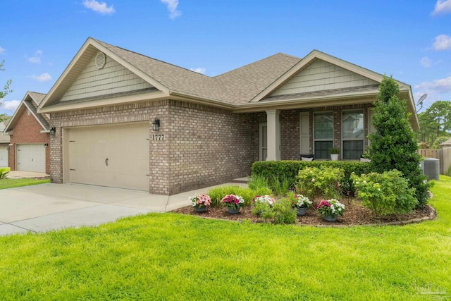 1777 Waterford Sound Blvd, Gulf Breeze, FL 32563 - view of front of house featuring a garage, brick siding, a front lawn, central air condition unit, and concrete driveway