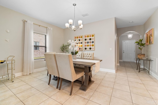 1777 Waterford Sound Blvd, Gulf Breeze, FL 32563 - dining area featuring arched walkways, light tile patterned floors, a chandelier, and baseboards