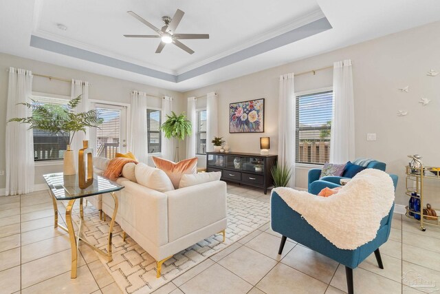 1777 Waterford Sound Blvd, Gulf Breeze, FL 32563 - living room with a tray ceiling, healthy amount of natural light, ceiling fan, ornamental molding, and light tile patterned flooring