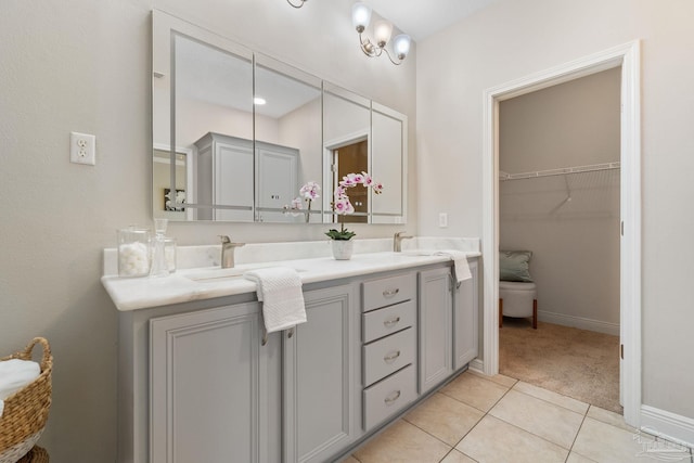1777 Waterford Sound Blvd, Gulf Breeze, FL 32563 - bathroom with double vanity, tile patterned flooring, baseboards, and a walk in closet