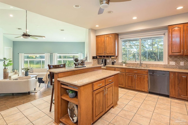 kitchen with dishwasher, decorative backsplash, a wealth of natural light, and sink