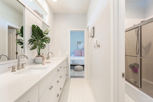 bathroom with tile patterned flooring, vanity, and enclosed tub / shower combo