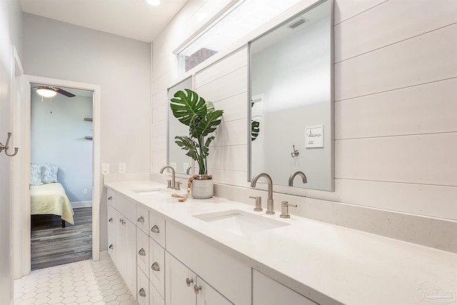 bathroom with ceiling fan, hardwood / wood-style floors, and vanity