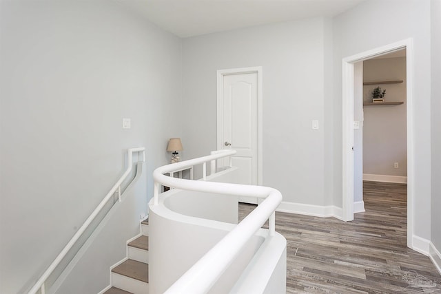 stairs featuring hardwood / wood-style floors