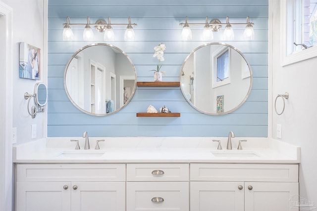 bathroom with vanity and wooden walls