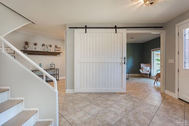 tiled foyer entrance featuring a barn door