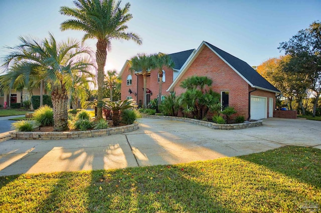 view of front of home with a garage and a front lawn