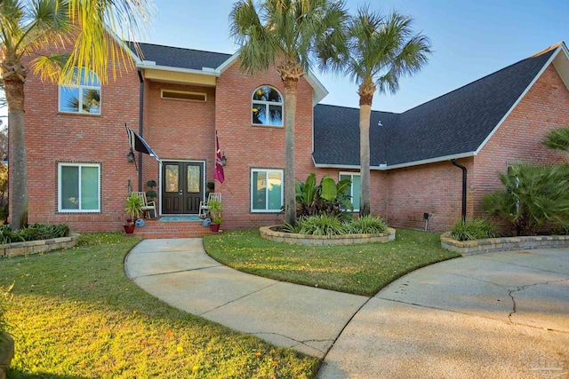 view of front of property with a front yard and french doors