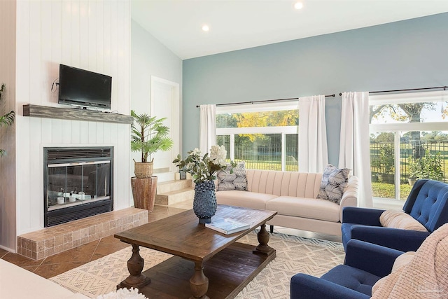 tiled living room with a fireplace and high vaulted ceiling