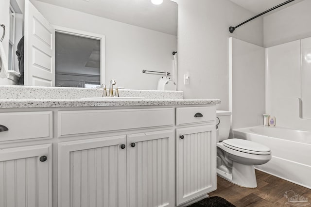 full bathroom featuring vanity, hardwood / wood-style floors,  shower combination, and toilet