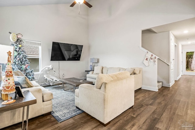 living room with dark hardwood / wood-style flooring and ceiling fan