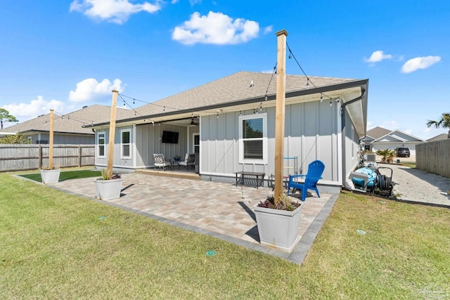 1519 Bonefish Ct, Gulf Breeze, FL 32563 - rear view of property featuring board and batten siding, a patio area, a ceiling fan, and a shingled roof