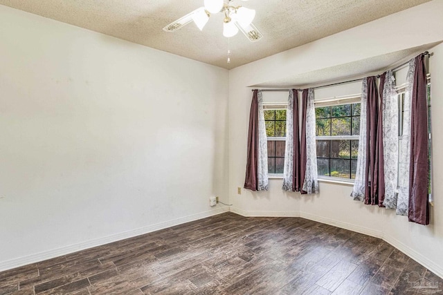 unfurnished room with dark hardwood / wood-style floors, ceiling fan, and a textured ceiling