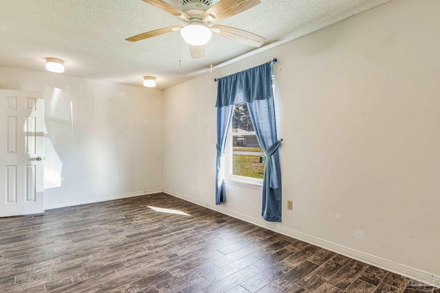 empty room featuring dark hardwood / wood-style floors, ceiling fan, and a textured ceiling