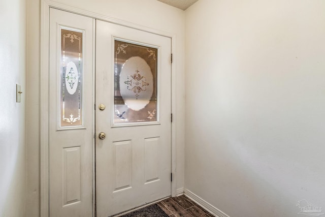 doorway featuring dark wood-type flooring