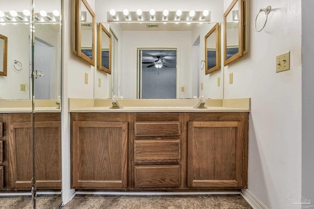 bathroom featuring vanity and ceiling fan with notable chandelier