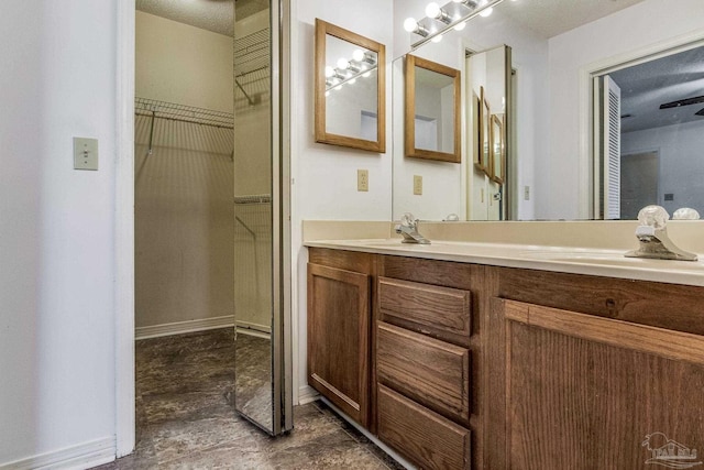 bathroom with a textured ceiling and vanity