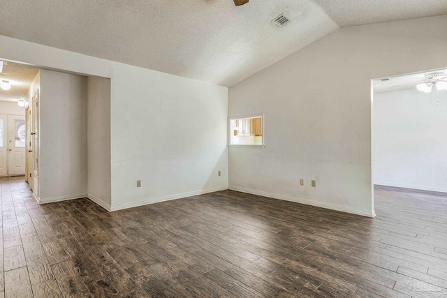 unfurnished room with french doors, a textured ceiling, vaulted ceiling, ceiling fan, and dark wood-type flooring