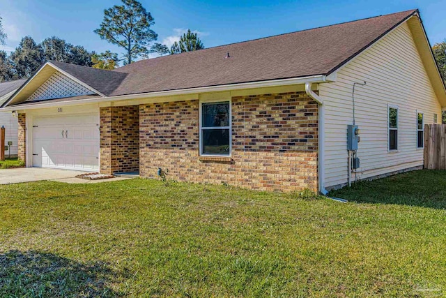 single story home with a garage and a front lawn