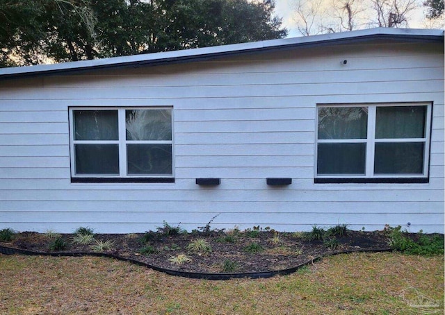 view of property exterior featuring a lawn