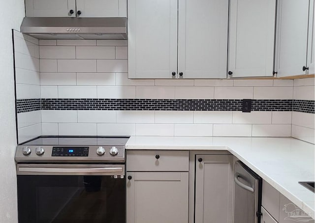 kitchen with gray cabinetry, stainless steel electric range, and backsplash