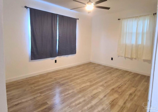 empty room with ceiling fan and light hardwood / wood-style floors