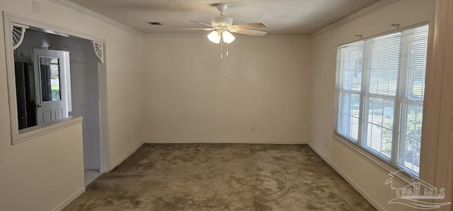 spare room with ceiling fan, carpet floors, a textured ceiling, and ornamental molding