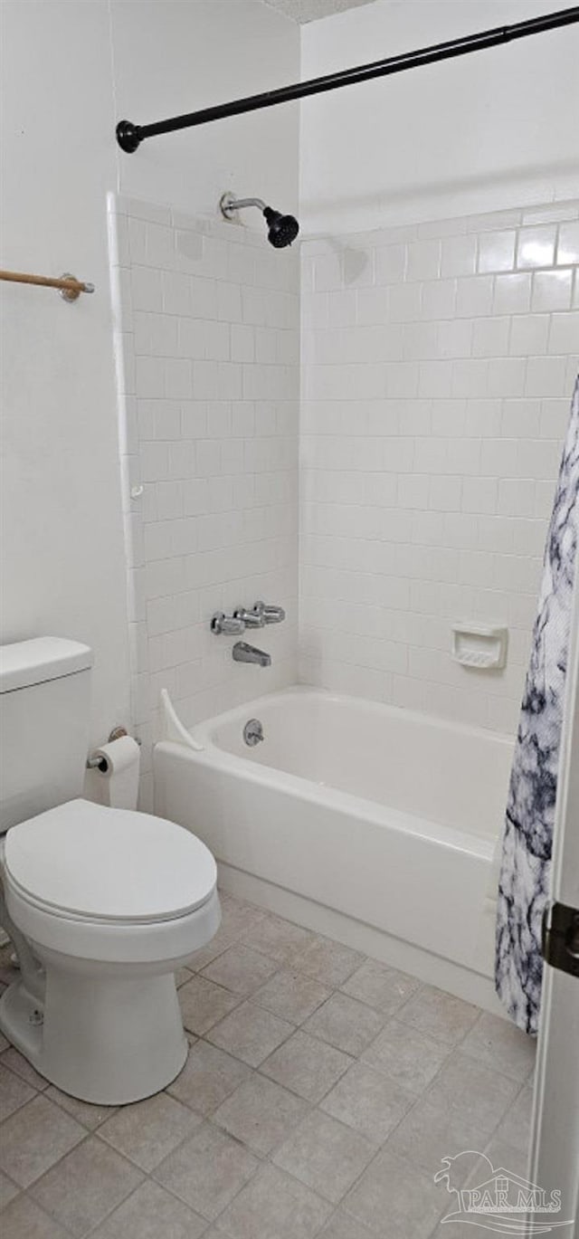 bathroom featuring shower / bath combination with curtain and toilet