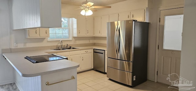 kitchen featuring a textured ceiling, sink, white cabinetry, and stainless steel appliances